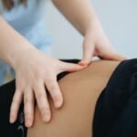 Close-up of a therapist providing back massage therapy in Vilnius.