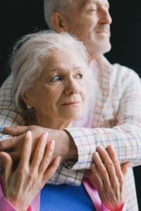An elderly couple sharing a tender moment, symbolizing love and companionship.